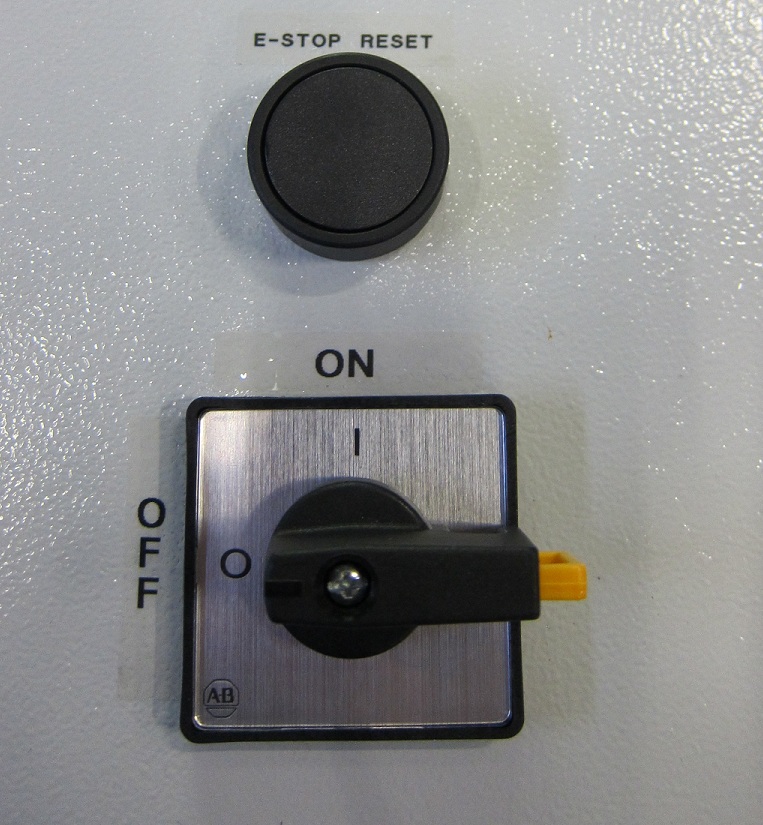 E-stop reset button (top) and main power switch on a sorter